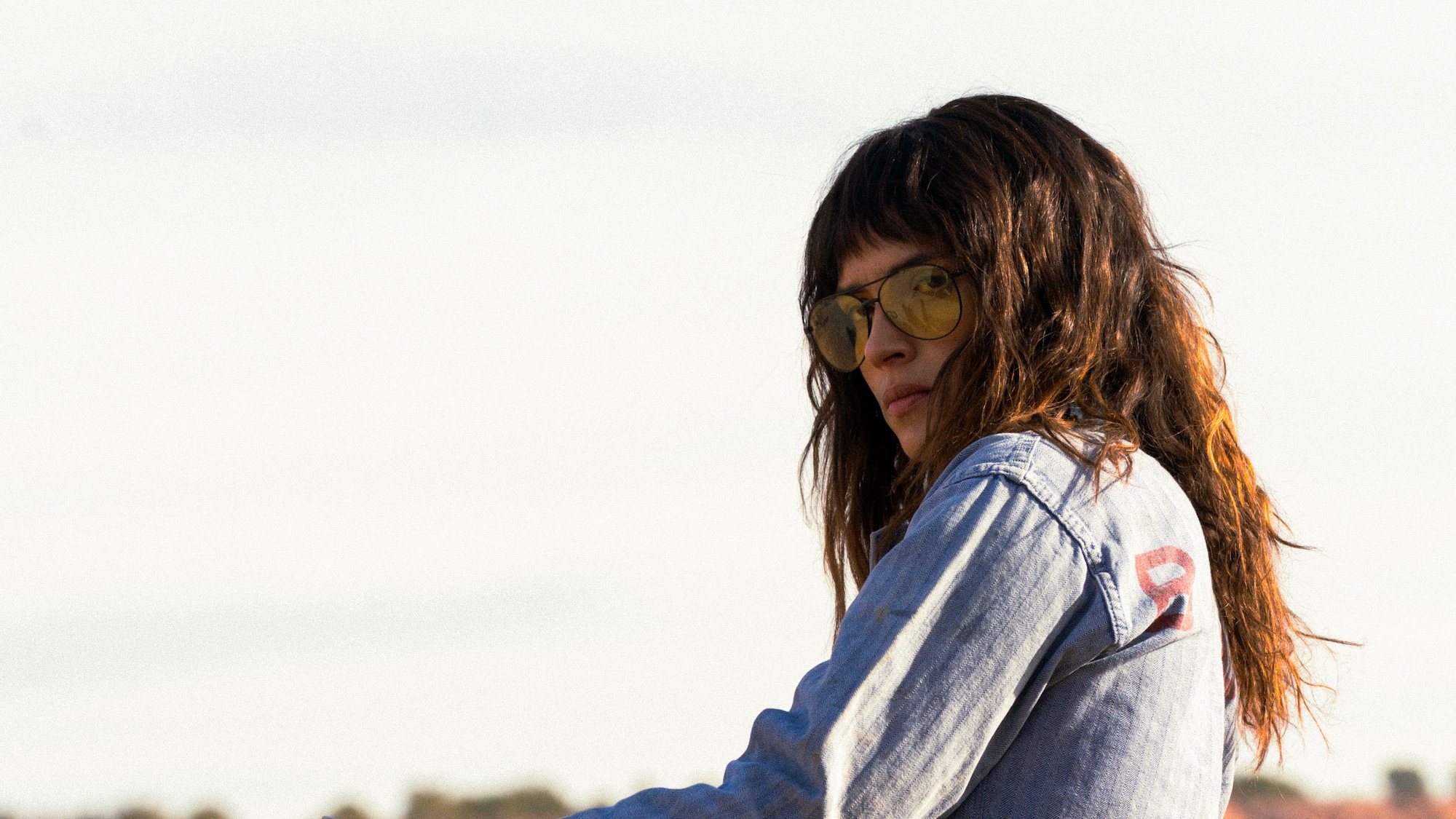 Adria Arjona wearing sunglasses in Onslaught.