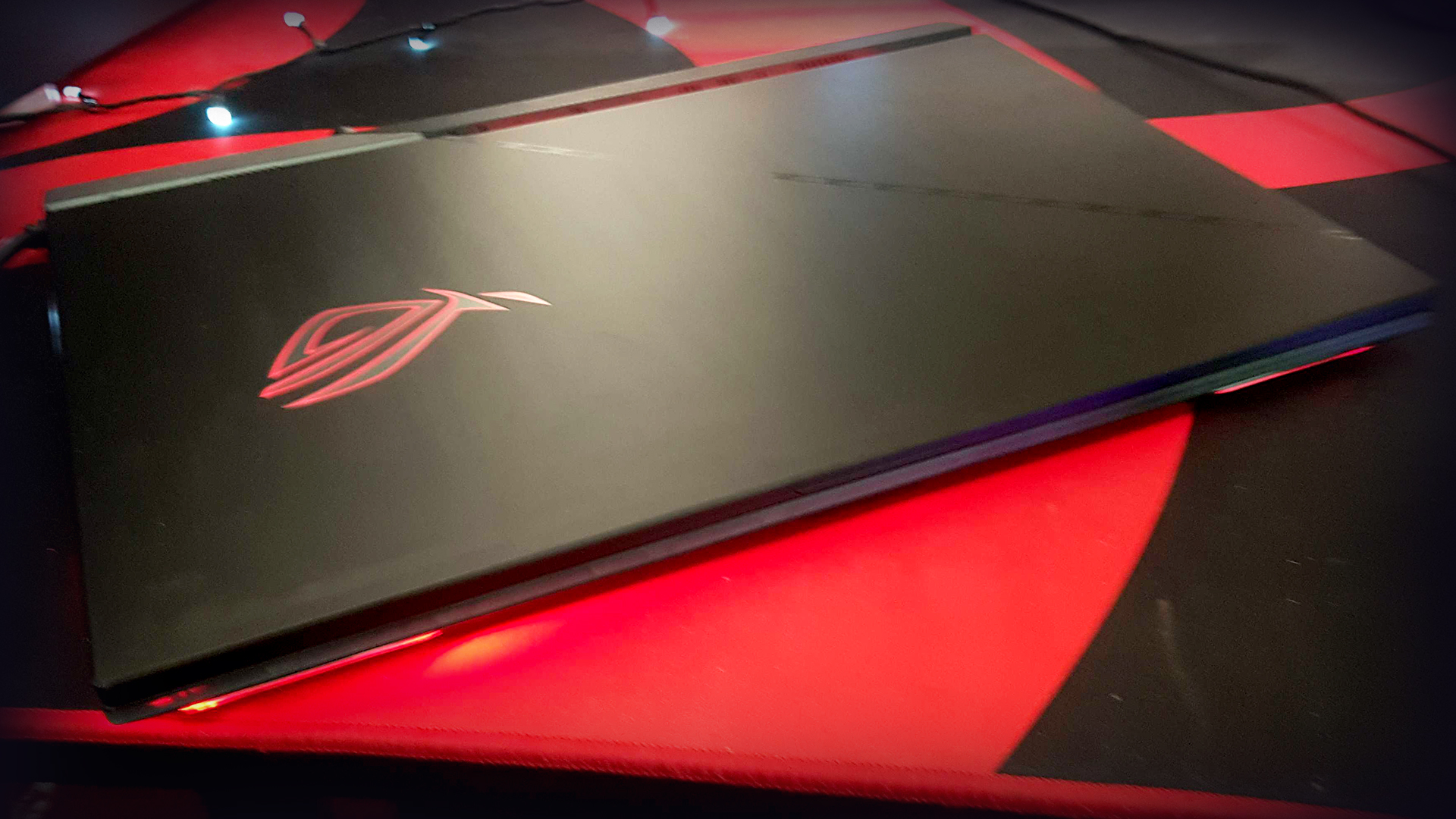 Asus ROG Strix Scar 17 with lid closed on a gaming desk.