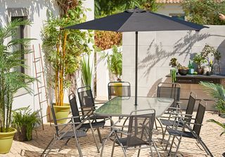 garden with six seater table and chair with parasol