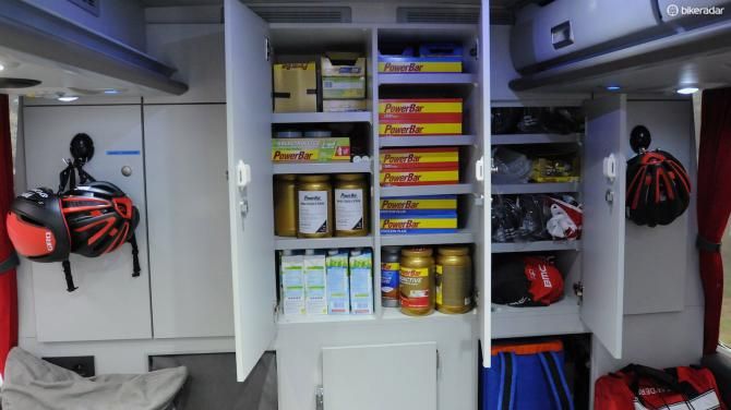 The many cupboards at the rear of the bus contain lots of race nutrition, team caps, medical supplies for injury treatment, and riders' spare kit