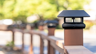 rail fence with lights fitted atop each post