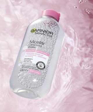 Garnier micellar cleansing solution in bottle on pink background