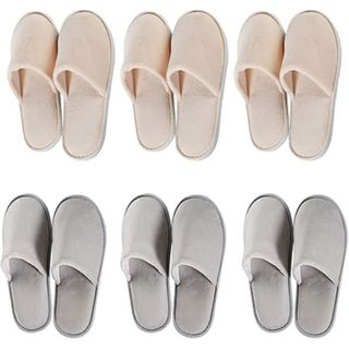 Three pairs of pink slippers above three pairs of grey slippers 