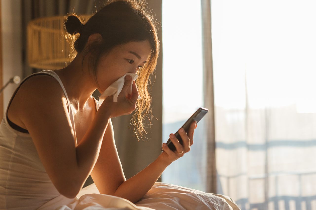 Coronavirus versus cold: A woman blowing her nose