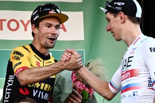 Primoz Roglic congratulates Tadej Pogacar after finishing third and first respectively at the 2023 Il Lombardia