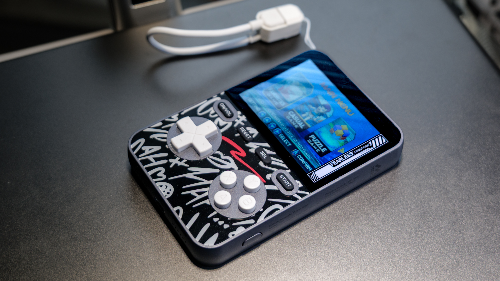 MIRO V99 Power Bank Gaming Console on top of metallic surface.
