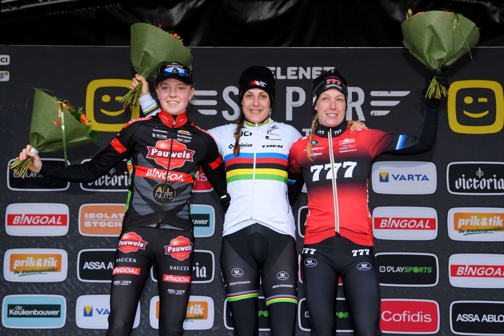 ZOLDER BELGIUM DECEMBER 27 LR Fem Van Empel of The Netherlands and Team Pauwels Sauzen Bingoal on second place race winner Lucinda Brand of The Netherland and Team Baloise Trek Lions and Annemarie Worst of The Netherlands and Team 777 on third place pose on the podium during the podium ceremony after the 17th Superprestige HeusdenZolder 2021 Womens Elite SuperprestigeCX SPHeusdenZolder on December 27 2021 in Zolder Belgium Photo by Luc ClaessenGetty Images