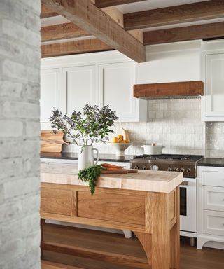 A white kitchen with exposed wood finishes