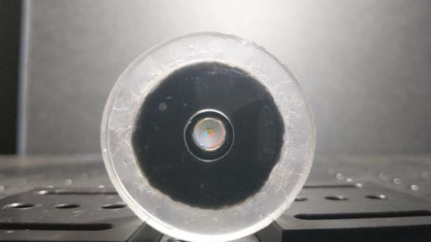 a robotic lens focuses on a tiny image of a Rubik&#039;s cube