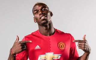 Paul Pogba of Manchester United poses after signing for the club at Aon Training Complex on August 8, 2016 in Manchester, England. 
