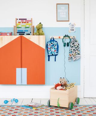 Kids bedroom with blue wall and house shaped storage