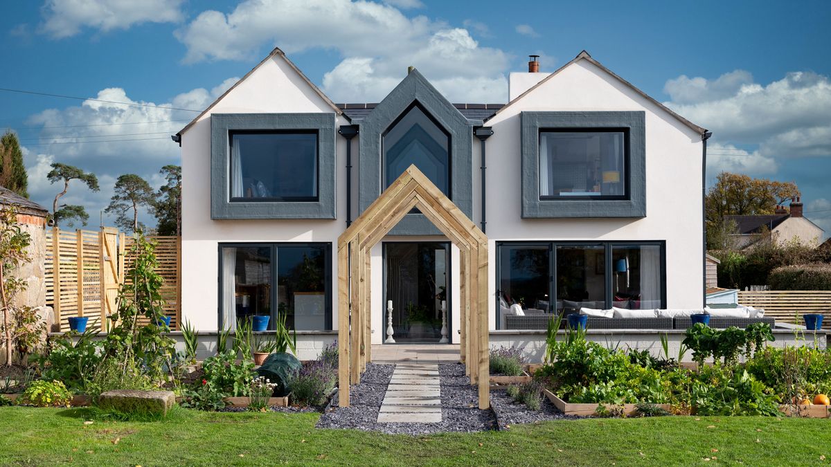 renovated and extended house with white render and grey windows