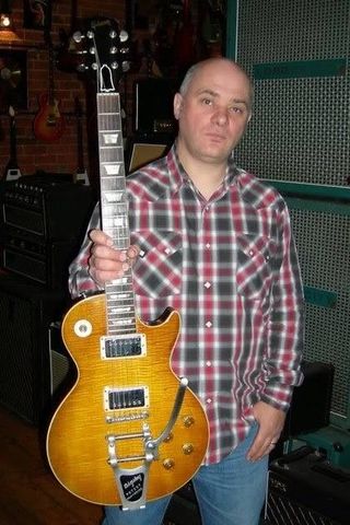 Guitar dealer Richard Henry holding the 1959 Gibson Les Paul Standard owned by Keith Richards known as the Keith 'Burst