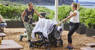 Ash (Martin Ashford), distracted after his conversation with Tori, pushes his stroller away and bumps into Liz and her pram in Home and Away.