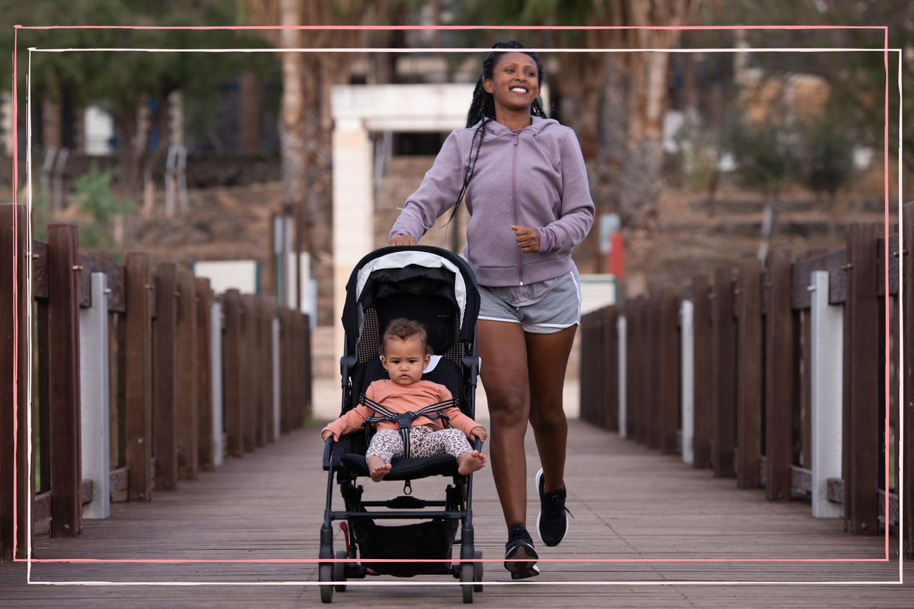 Mother with baby stroller running in the park