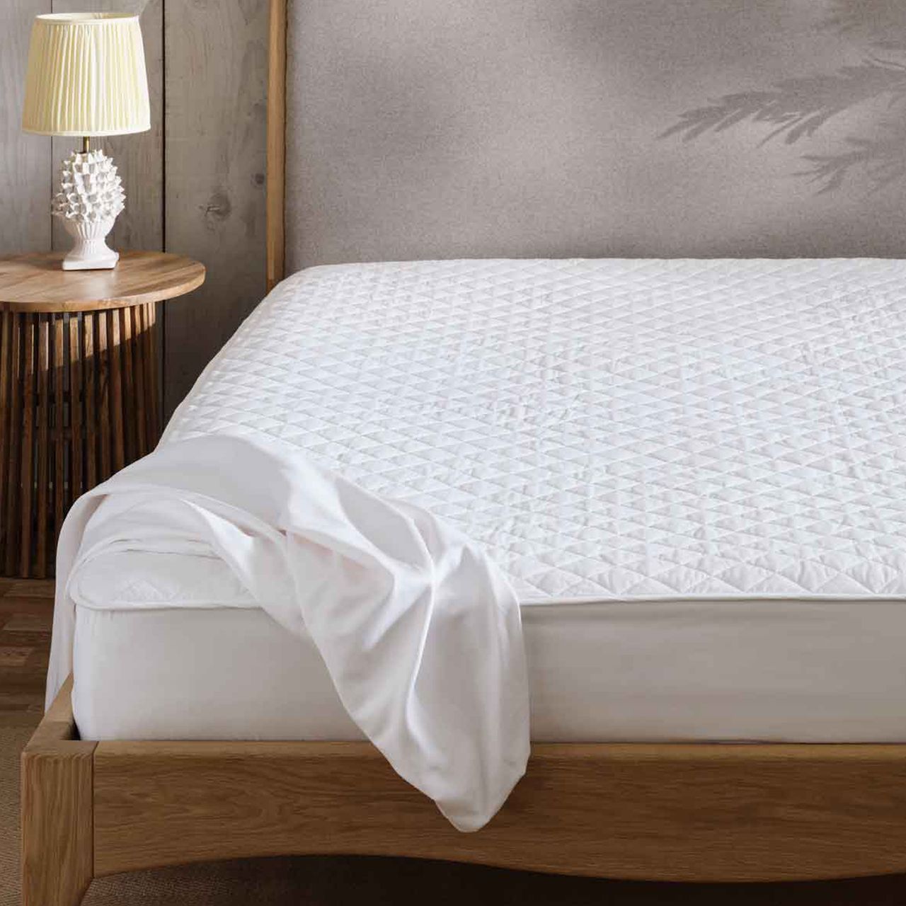 scooms 100% Pure Cotton Mattress Protector on a wooden bed.