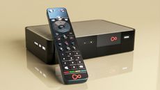 Virgin TV 360 box and remote on a yellow backdroup