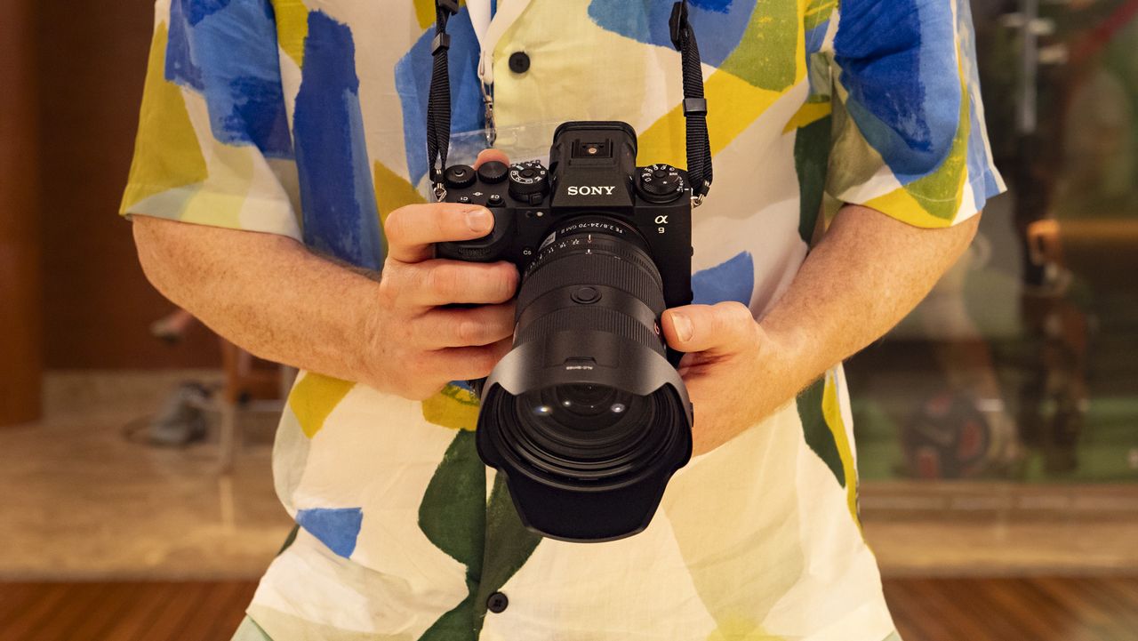Sony A9 III in the hand with lens attached