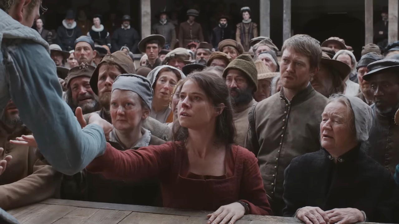 Jessie Buckley grabbing hand in Hamnet.