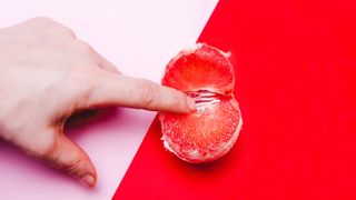 hand touching fruit on bright background