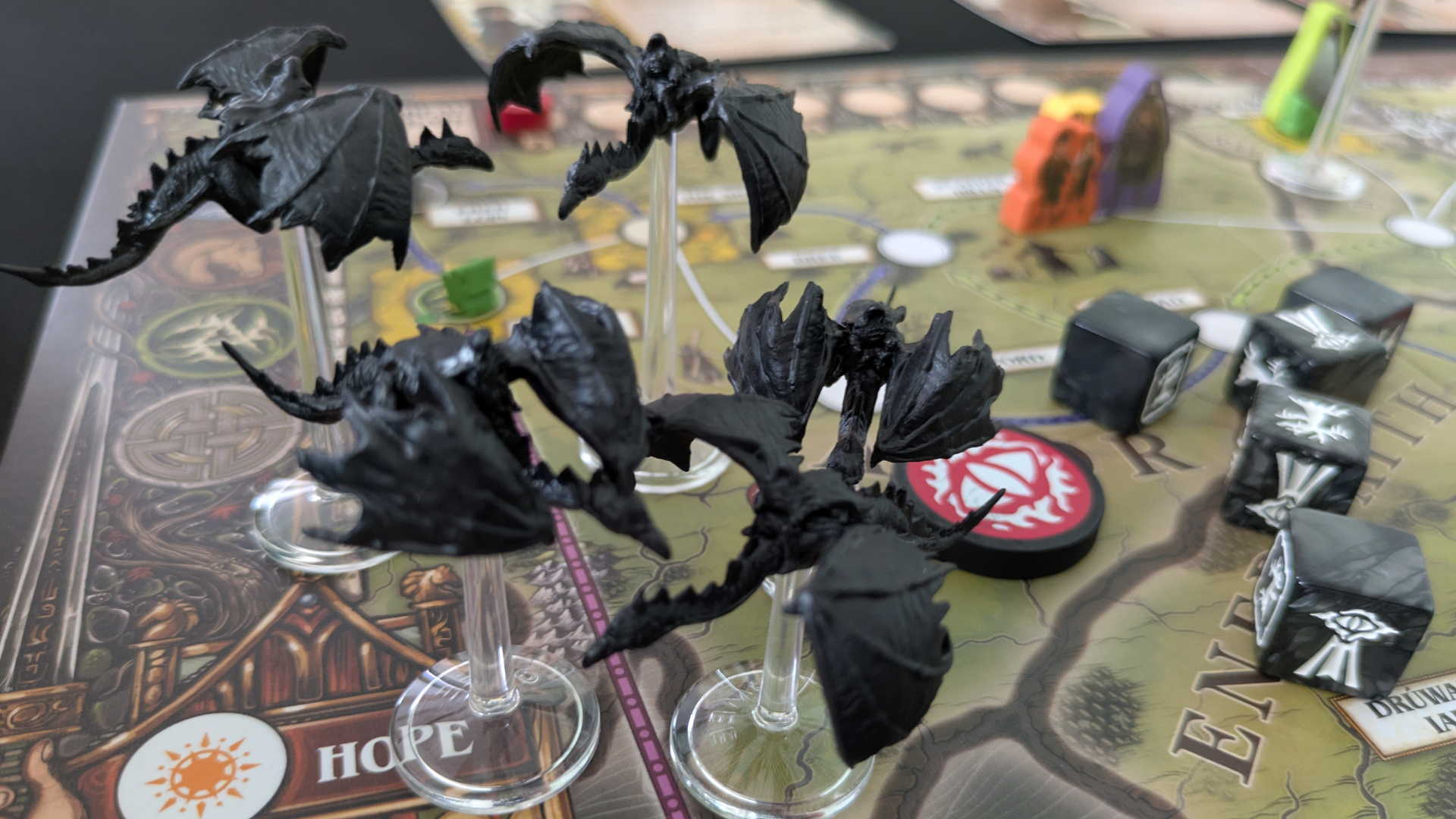 Numerous Ringwraith models alongside tokens and dice on the Fate of the Fellowship board