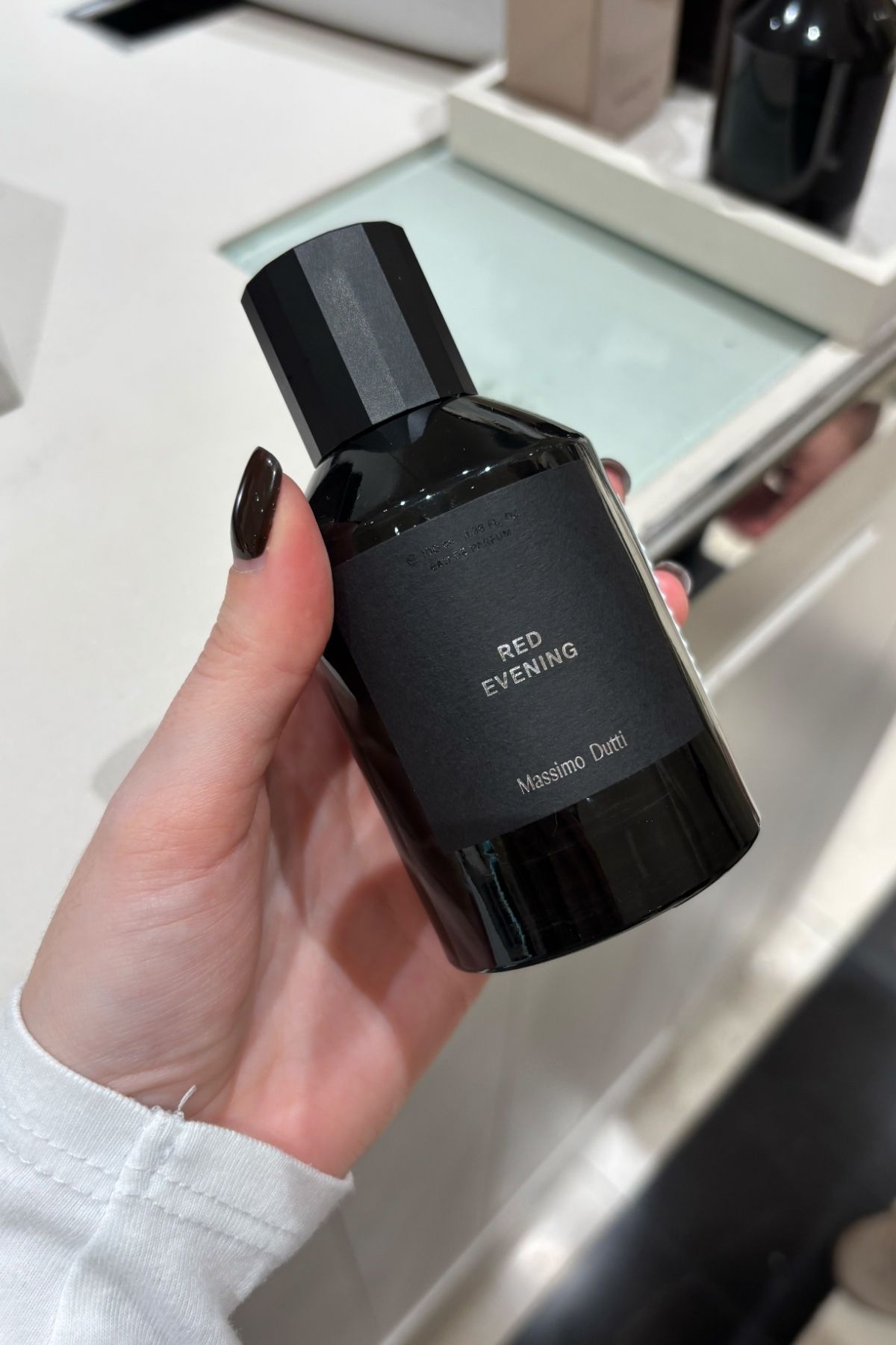 Deputy beauty editor Grace Lindsay holding a bottle of Massimo Dutti Red Evening