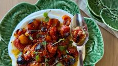Plate or roast tomatoes and yogurt on a green dish