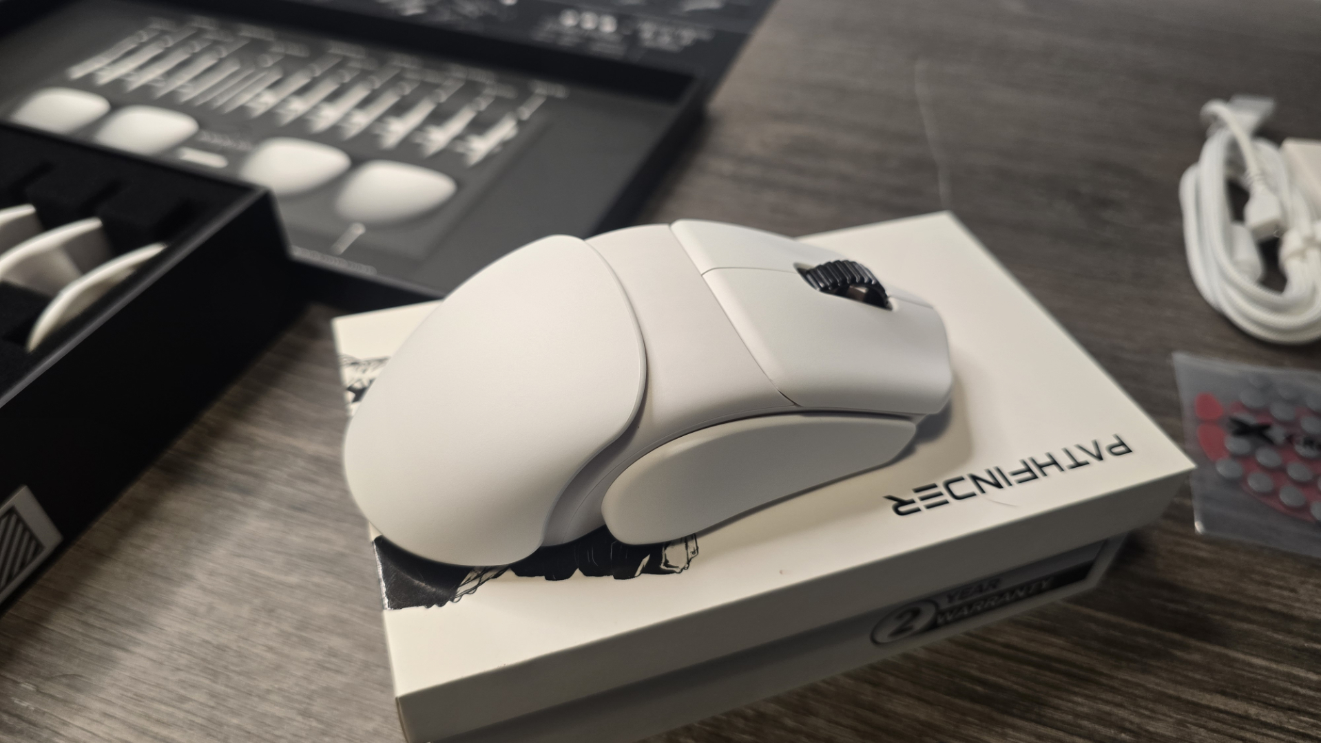 Orbital Pathfinder gaming mouse with various attachments.