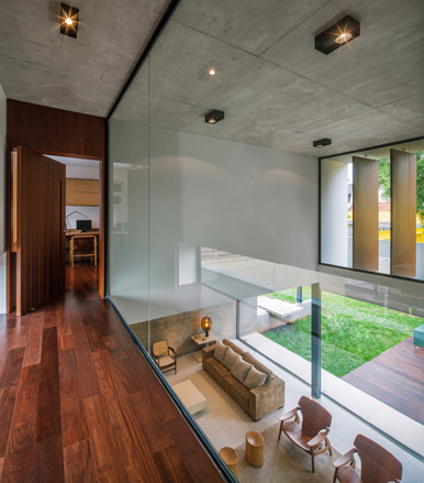 Glass walls along the second floor landing add further transparency to an already open plan design