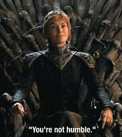 Cersei tilts her head to the side as she sits on the throne. A subtitle reads "You're not humble."