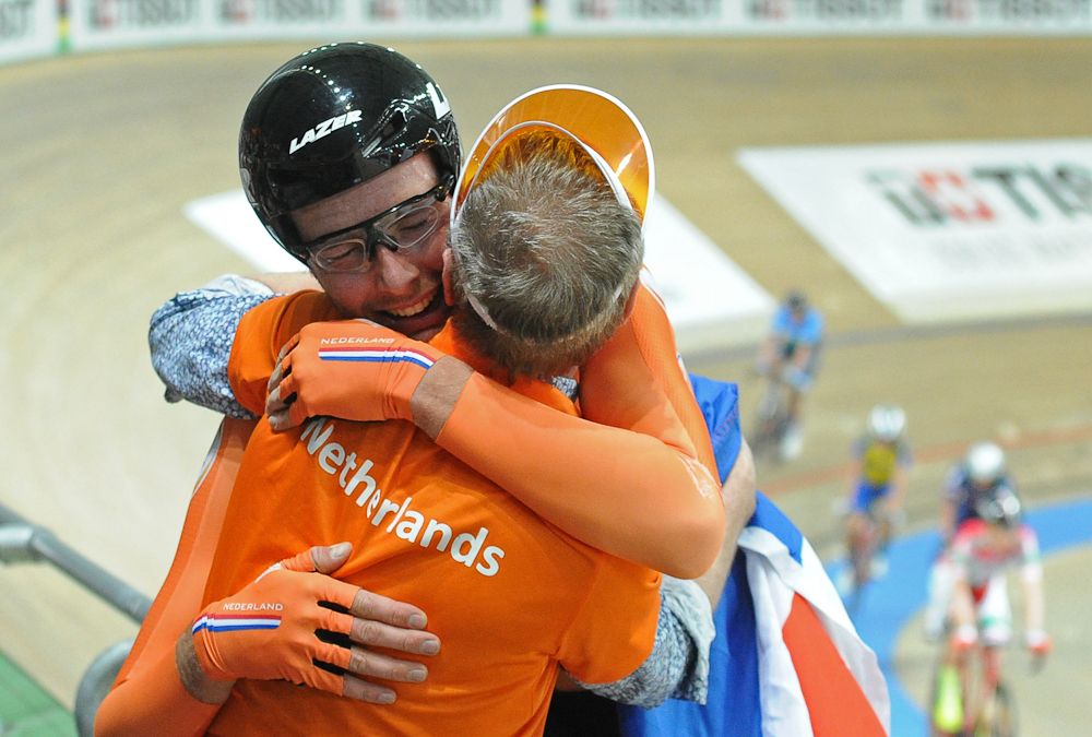 The Netherlands' Jan-Willem van Schip (L) celebrates with a team member after winning the Men's Points Race 40 km at the UCI Track Cycling World Championships