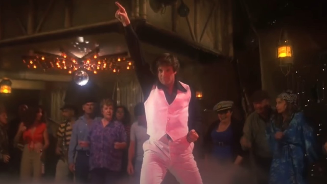 Ted striking a disco pose a la John Travolta in Saturday Night Fever in Airplane!