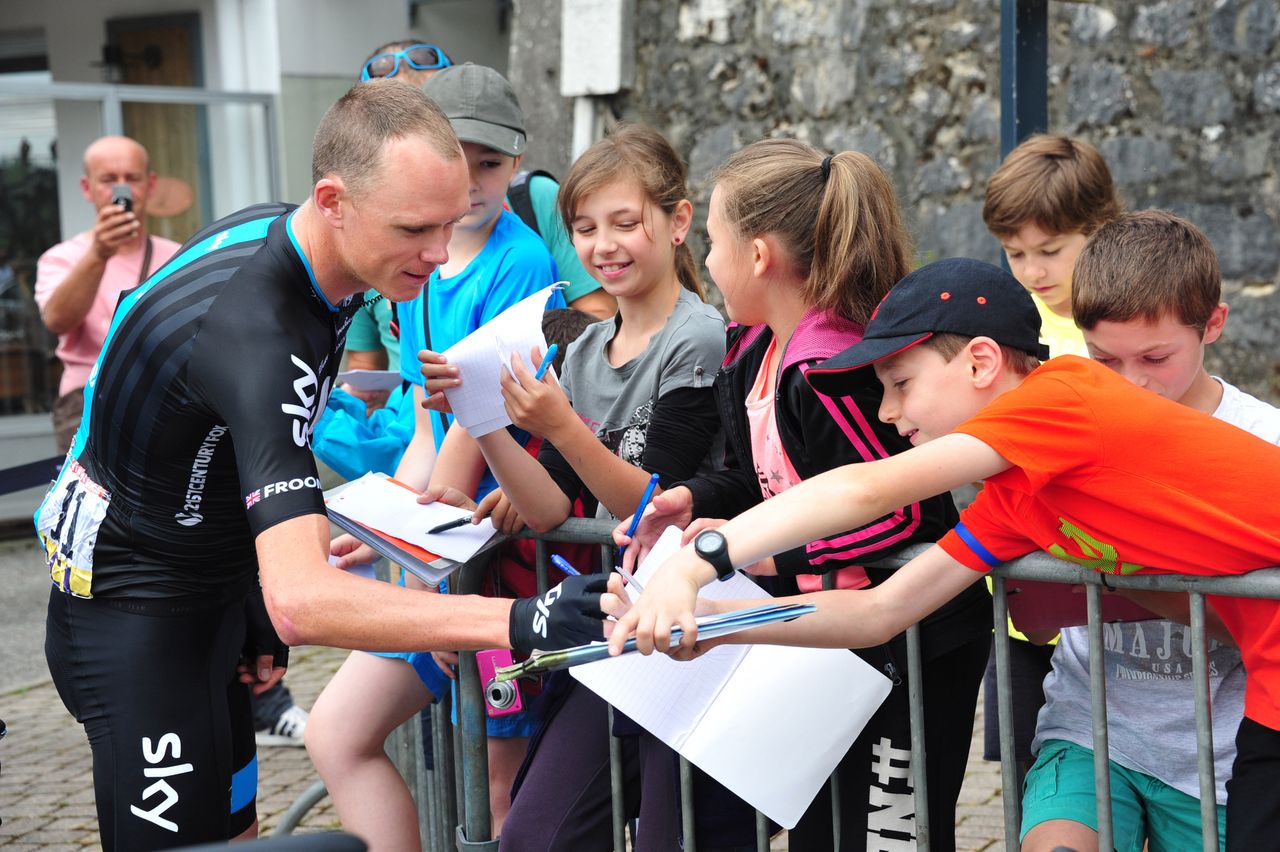 Chris Froome (Team Sky) signs autographs ahead of the stage