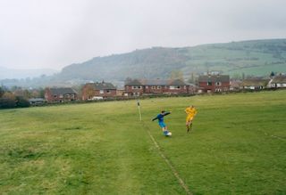 Two people playing football- Mytholmroyd, England,
