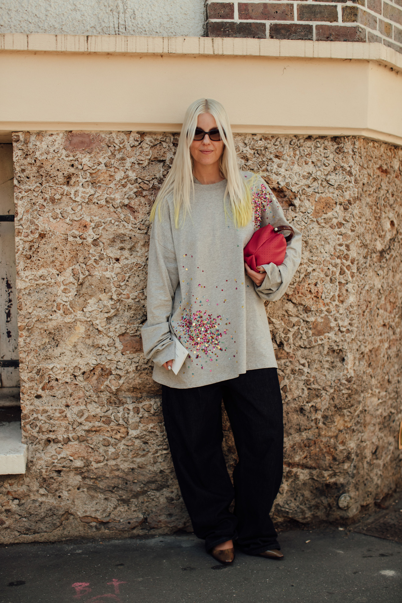 woman wearing an embellished gray top in Paris
