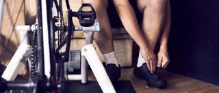 a photo of a man sat by a turbo trainer