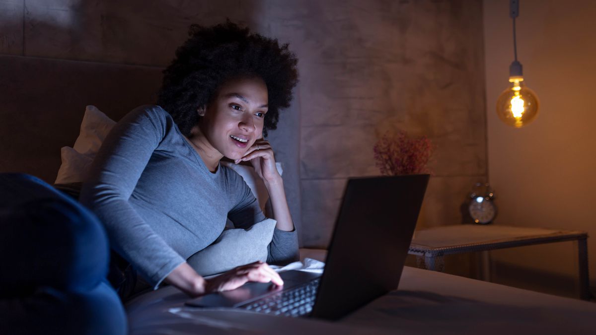 Woman watching a laptop in bed