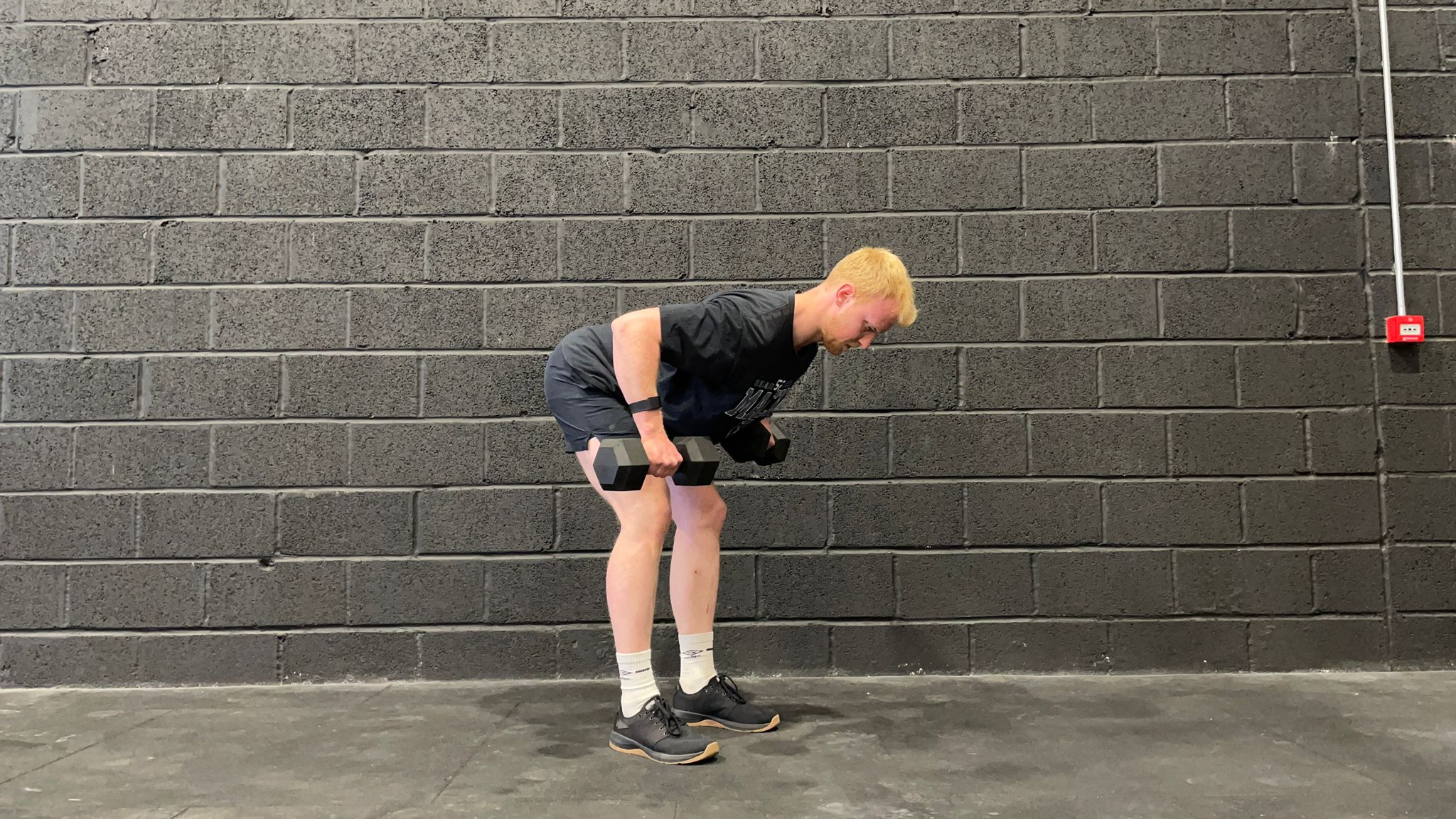 TechRadar fitness writer Harry Bullmore demonstrating a dumbbell bent-over row