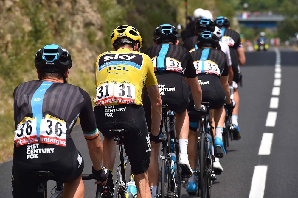 Chris Froome is surrounded by teammates during stage 14.
