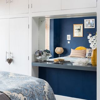 bedroom with cupboard and dark blue