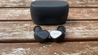 Jabra Elite 3 earbuds out of the case on a table outside