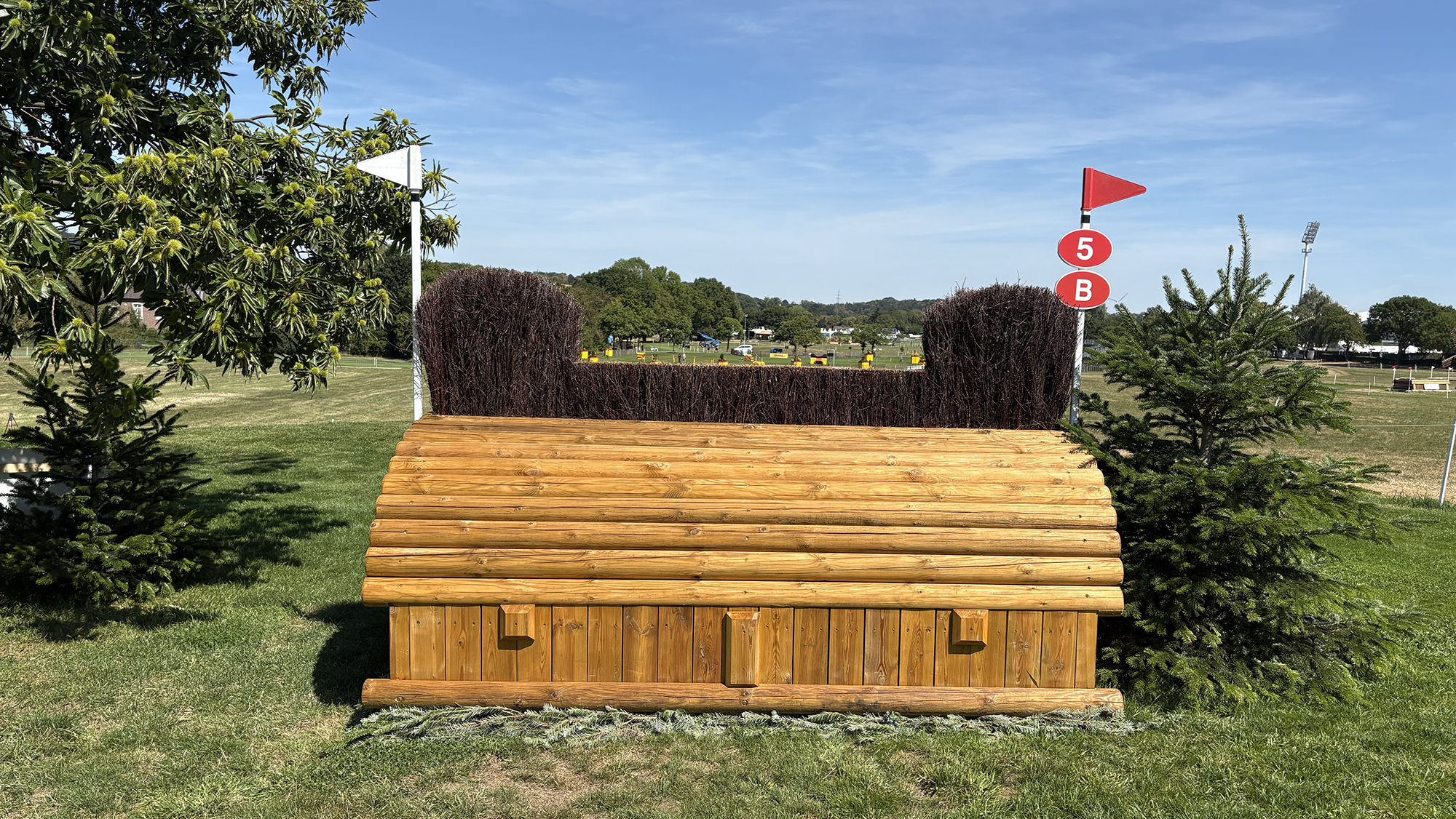 A fence made of wood with brush on top on the eventing World Championships cross-country course