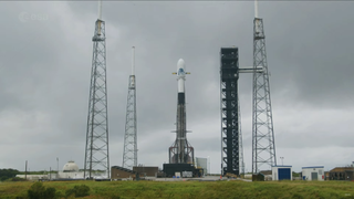 A white and black rocket on the launch pad under gray skies ahead of the Hera asteroid mission launch on Oct. 7, 2024.