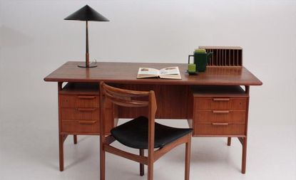 A brown wooden office desk and chair