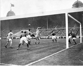Cardiff City's Billy Hardy jumps highest to clear a Arsenal attack during the first half of the final - Left to Right -Len Davies, Tom Watson, Jimmy Brain, Tom Sloan, Billy Hardy, Billy Blyth, Tom Farquharson