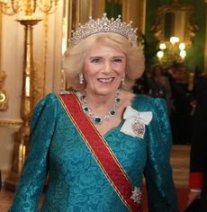 Queen Camilla wearing the Girls of Great Britain and Ireland tiara and a teal gown