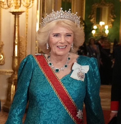 Queen Camilla wearing the Girls of Great Britain and Ireland tiara and a teal gown