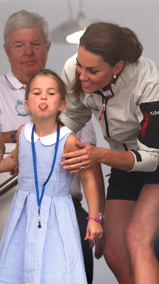 Princess Charlotte of Cambridge sticks out her tongue much to the amusement of her mother Catherine, Duchess of Cambridge, following the inaugural King's Cup regatta hosted by the Duke and Duchess of Cambridge on August 08, 2019 in Cowes, England