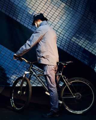 Man in CP Company on bike with blur effect