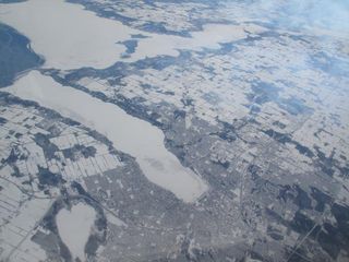 The snow-covered city of Barrie, Ontario, Canada, surrounds ice-bound Lake Simcoe in this view from NASA's DC-8 airborne science laboratory during a flight Feb. 20 in NASA's Global Precipitation Measurement Cold-season Precipitation Experiment, or GCPEx, mission.